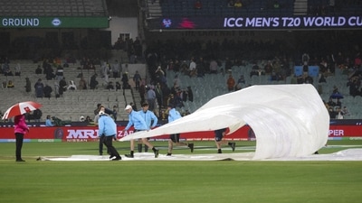 Ground staff place covers over the wicket as rain causes the cancelation of the T20 World Cup cricket match between Australia and England in Melbourne, Australia, Friday, Oct. 28, 2022. (AP)