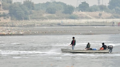 A team of Delhi Jal Board sprays chemicals into the Yamuna river to dissolve the toxic foam seen floating in the river, at Kalindi Kunj, on Friday. (ANI Photo) A team of Delhi Jal Board sprays chemicals into the Yamuna river to dissolve the toxic foam seen floating in the river, at Kalindi Kunj, on Friday. (ANI Photo)