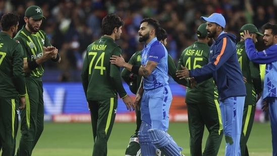 India's Virat Kohli shakes hands with Pakistan's Mohammad Wasim following the T20 World Cup cricket match between India and Pakistan in Melbourne, Australia, Sunday, Oct. 23, 2022. (AP Photo/Asanka Brendon Ratnayake)(AP)