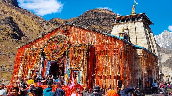 Devotees visit Kedarnath Temple to offer prayers, in Kedarnath on Thursday.(ANI)