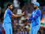 India's Bhuvneshwar Kumar, left, is congratulated by a teammate KL Rahul