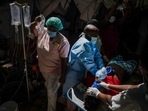 Cholera In Haiti: A nurse carries a saline drip amid Cholera spike in Haiti.(AP)