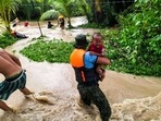 Rescuers help residents evacuate in Kalamansig, Sultan Kudarat on October 28, 2022, due to heavy rains resulting in floodings brought by Tropical Storm Nalgae.(AFP) Rescuers help residents evacuate in Kalamansig, Sultan Kudarat on October 28, 2022, due to heavy rains resulting in floodings brought by Tropical Storm Nalgae.(AFP)