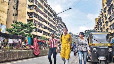 Indian poet and writer Jerry Pinto walks with two local girls as he interacts with them at Lallubhai Compound, Govandi, in Mumbai, India, on Wednesday, October 19, 2022. (Photo by Pratik Chorge/Hindustan Times) (Pratik Chorge/HT PHOTO) Indian poet and writer Jerry Pinto walks with two local girls as he interacts with them at Lallubhai Compound, Govandi, in Mumbai, India, on Wednesday, October 19, 2022. (Photo by Pratik Chorge/Hindustan Times) (Pratik Chorge/HT PHOTO)