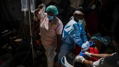 Cholera In Haiti: A nurse carries a saline drip amid Cholera spike in Haiti. (AP) Cholera In Haiti: A nurse carries a saline drip amid Cholera spike in Haiti. (AP)