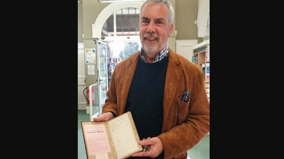 The image, taken from the Instagram post, shows the grandson holding the library book that he returned 84 years after his grandpa borrowed it. (Instagram/@earlsdoncommunitylibrary)