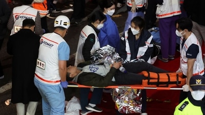 A man receives medical help at the scene where dozens of people were injured in a stampede during a Halloween festival in Seoul, South Korea. (REUTERS)