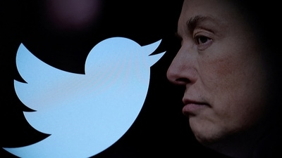 Twitter logo and a photo of Elon Musk are displayed through magnifier in this illustration. (REUTERS)