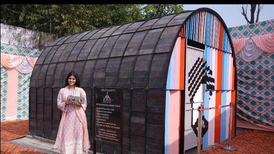 Ruhani Verma with the toilet constructed with recyclable material at Sri Guru Ram Dass Jee International Airport in Amritsar. (HT Photo)