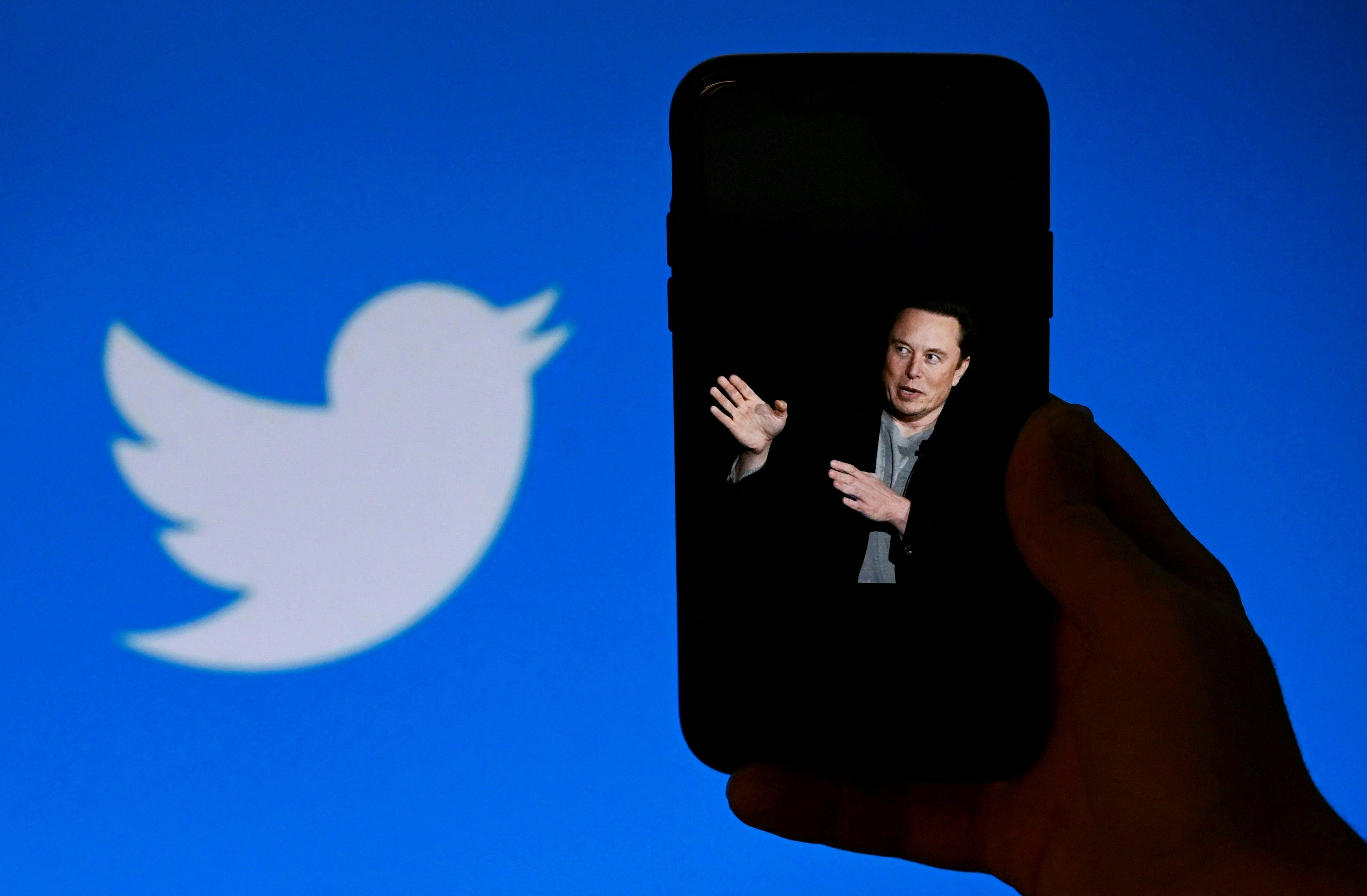 A phone screen displays a photo of Elon Musk with the Twitter logo. (AFP) A phone screen displays a photo of Elon Musk with the Twitter logo. (AFP)
