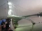 Morbi: The collapsed portion of an old suspension bridge over the Machchhu river, in Morbi district, Gujarat. (PTI) Morbi: The collapsed portion of an old suspension bridge over the Machchhu river, in Morbi district, Gujarat. (PTI)