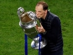 Thomas Tuchel celebrates with the trophy after winning the Champions League.