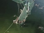 Rescue operation underway after a cable bridge collapsed on the Machchhu river, in Morbi on Sunday. (ANI Photo) Rescue operation underway after a cable bridge collapsed on the Machchhu river, in Morbi on Sunday. (ANI Photo)