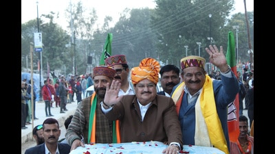 Bharatiya Janata Party (BJP) national president JP Nadda greets the supporters during a roadshow ahead of the Himachal Pradesh assembly elections in Kullu on Sunday. (Aqil Khan/HT) Bharatiya Janata Party (BJP) national president JP Nadda greets the supporters during a roadshow ahead of the Himachal Pradesh assembly elections in Kullu on Sunday. (Aqil Khan/HT)