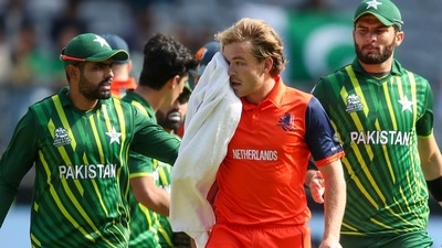 Bas de Leede, centre, leaves the field after her was hit on the face while batting during the T20 World Cup cricket match between the Netherlands and Pakistan in Perth. (AP)