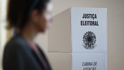 Brazil Elections: A Brazilian citizen passes by a voting booth for Brazil's election. (Reuters)