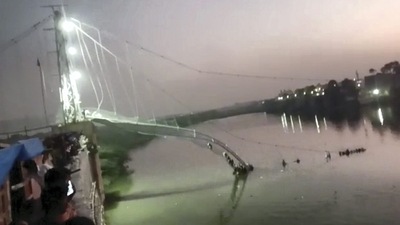 Morbi: The collapsed portion of an old suspension bridge over the Machchhu river, in Morbi district, Gujarat. (PTI) Morbi: The collapsed portion of an old suspension bridge over the Machchhu river, in Morbi district, Gujarat. (PTI)