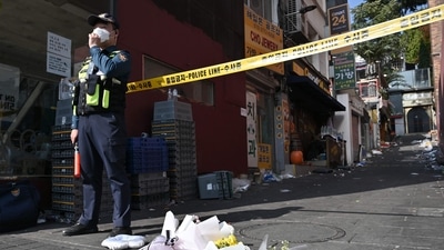 South Korea Halloween Stampede: Flowers are laid at the scene of a Halloween stampede. (AFP) South Korea Halloween Stampede: Flowers are laid at the scene of a Halloween stampede. (AFP)