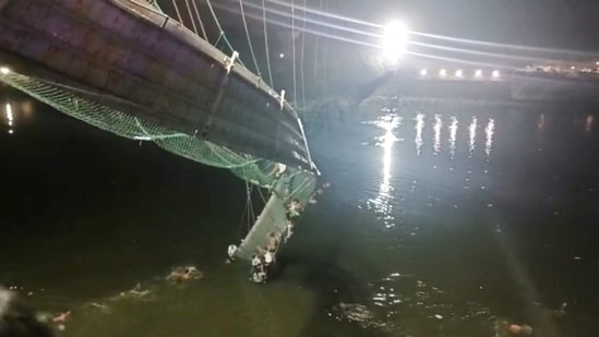 Morbi News Today: Rescue operation underway after an old suspension bridge over the Machchhu river collapsed, in Morbi district, Sunday, Oct. 30, 2022. 