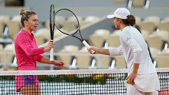 Iga Swiatek (in white) with Simona Halep(Getty/File Photo)