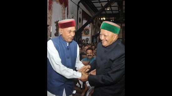 Former CMs Prem Kumar Dhumal and Virbhadra Singh sharing a light moment in this undated photo. (HT File Photo)