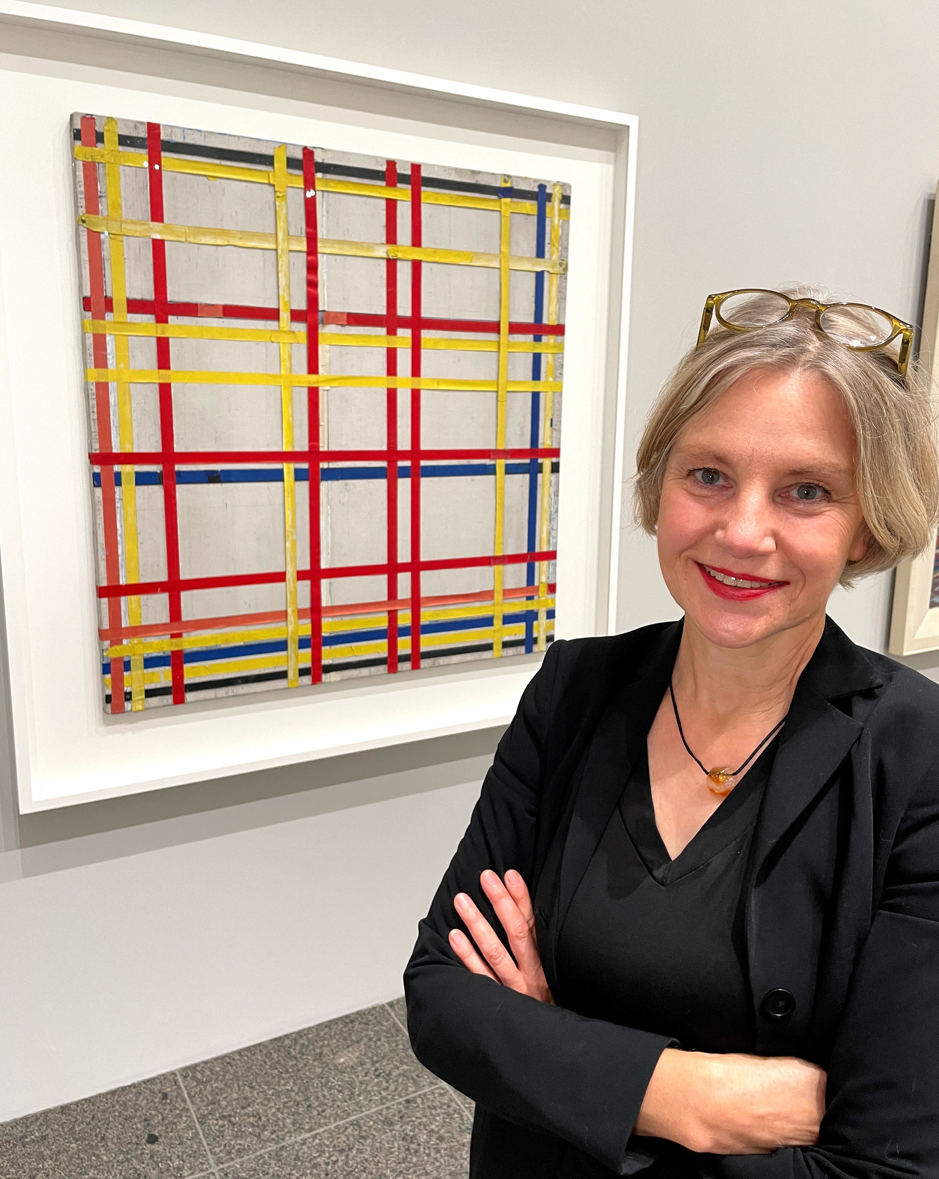 Curator Susanne Meyer-Bueser poses in front of the Piet Mondrian painting "New York City I" in the Kunstsammlung NRW after it has been hanging upside down for 77 years in Duesseldorf, Germany, October 28, 2022. (REUTERS/Petra Wischgoll)