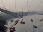 Rescuers search for survivors after a suspension bridge collapsed in Morbi town in the western state of Gujarat, India, 