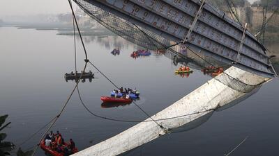 Rescue operations underway after the collapse of a suspension bridge over the Machchhu river in Gujaray’s Morbi on Sunday night. (PTI Photo) Rescue operations underway after the collapse of a suspension bridge over the Machchhu river in Gujaray’s Morbi on Sunday night. (PTI Photo)