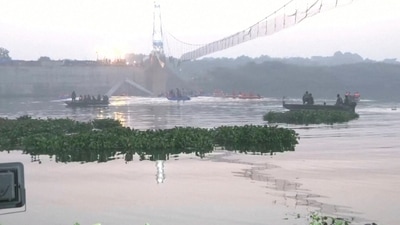 Rescuers in boats work at the site of a suspension bridge collapse in Morbi town in the western state of Gujarat, India, (via REUTERS)