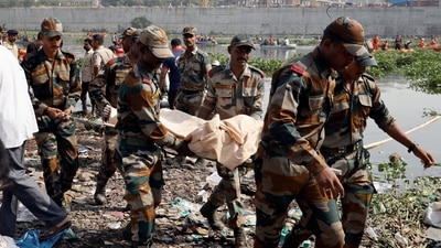 Army soldiers carry the body of a victim after a suspension bridge collapsed in Morbi town in Gujarat. (REUTERS)