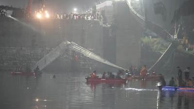 Rescuers on boats search in the Machchu river next to a cable bridge that collapsed in Morbi town of western state Gujarat, India, Monday, Oct. 31, 2022. The century-old cable suspension bridge collapsed into the river Sunday evening, sending hundreds plunging in the water, officials said. (AP Photo/Ajit Solanki) (AP)