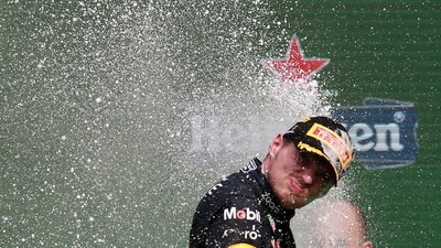 Red Bull's Max Verstappen celebrates on the podium after winning the race and setting a new F1 record of 14 grand prix wins (REUTERS)