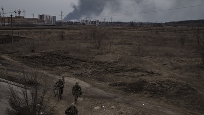 Russia-Ukraine War: Soldiers walk on a path as smoke billows from the town of Irpin. (AP)