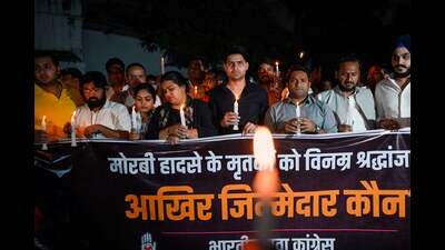Members of India's Youth Congress take part in a candlelight march in New Delhi on October 31, 2022, to pay homage to the victims who died after a bridge across the river Machchhu collapsed at Morbi in India's Gujarat state. (AFP) Members of India's Youth Congress take part in a candlelight march in New Delhi on October 31, 2022, to pay homage to the victims who died after a bridge across the river Machchhu collapsed at Morbi in India's Gujarat state. (AFP)