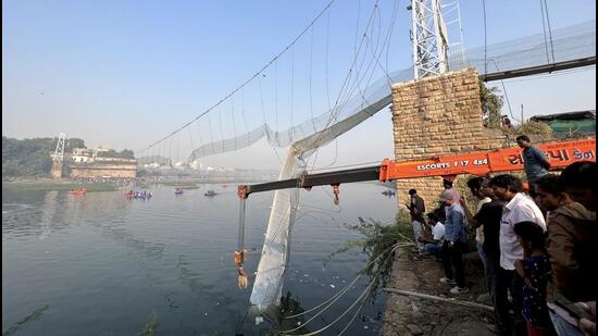 Rescue operations underway in Morbi on Monday after a suspension bridge collapsed over the Machchhu river in Gujarat on Sunday night. (PTI Photo)