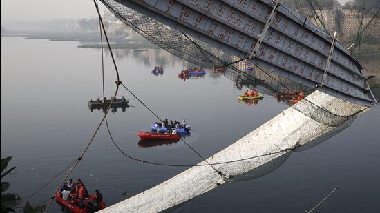 Rescue operations underway after the collapse of a suspension bridge over the Machchhu river in Gujaray’s Morbi on Sunday night. (PTI Photo) Rescue operations underway after the collapse of a suspension bridge over the Machchhu river in Gujaray’s Morbi on Sunday night. (PTI Photo)