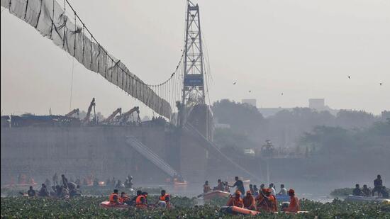 Rescuers search for survivors after a suspension bridge collapsed in Morbi town in Gujarat on Sunday. (REUTERS)