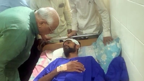 Gujarat chief minister Bhupendra Patel meets with a victim who got injured in the cable bridge collapse mishap at a hospital on Sunday. (ANI )