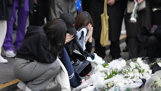 Women pray for victims of a deadly accident following Saturday night's Halloween festivities in Seoul, South Korea.(AP)