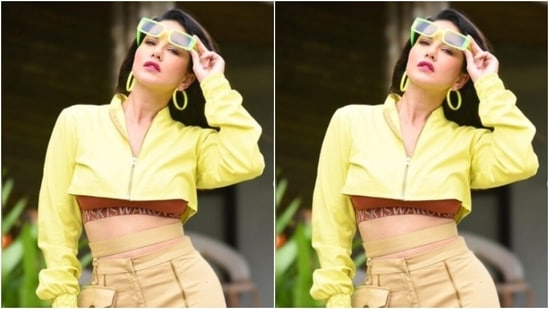 Sunny embraced summer in a maroon sports bra and layered it with a bright neon yellow cropped jacket. In ochre trousers with cut-out details at the ankles, Sunny completed her look. (Instagram/@sunnyleone)