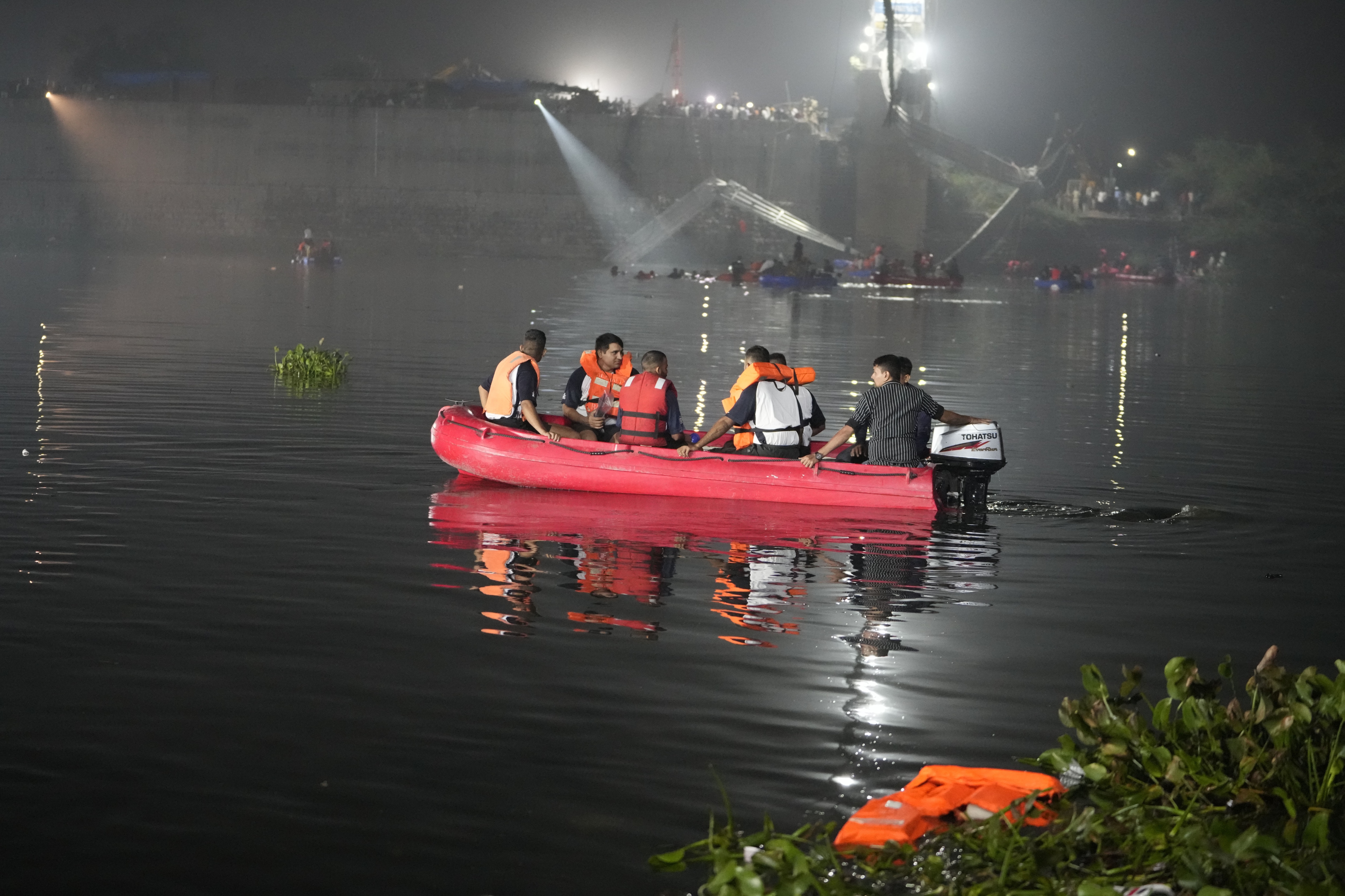 Rescuers on boats search in the Machchu river next to a cable bridge that collapsed in Morbi town of western state Gujarat. (AP)