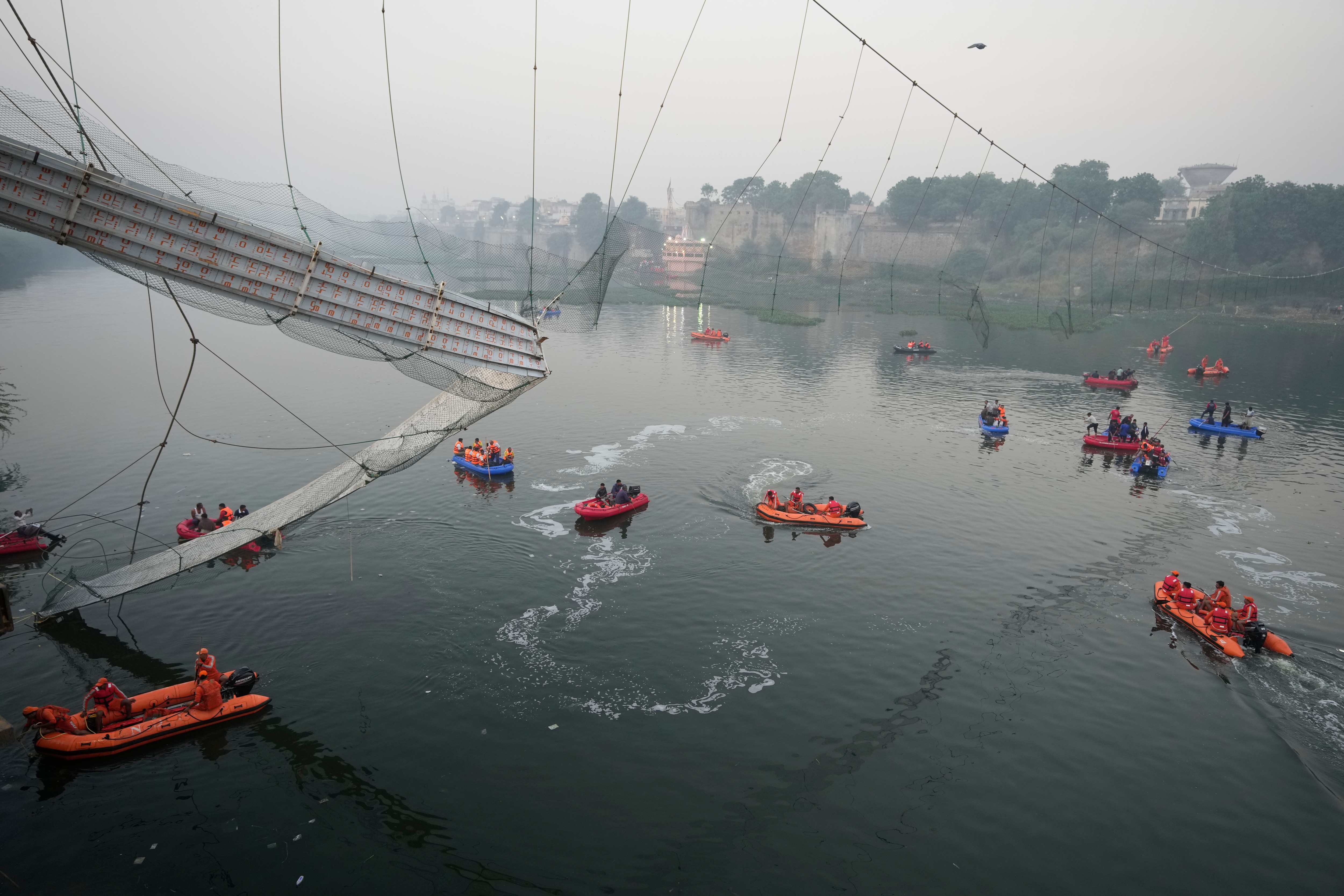 Search and rescue work is going on as a cable suspension bridge collapsed in Morbi town of western state Gujarat. (AP) Search and rescue work is going on as a cable suspension bridge collapsed in Morbi town of western state Gujarat. (AP)