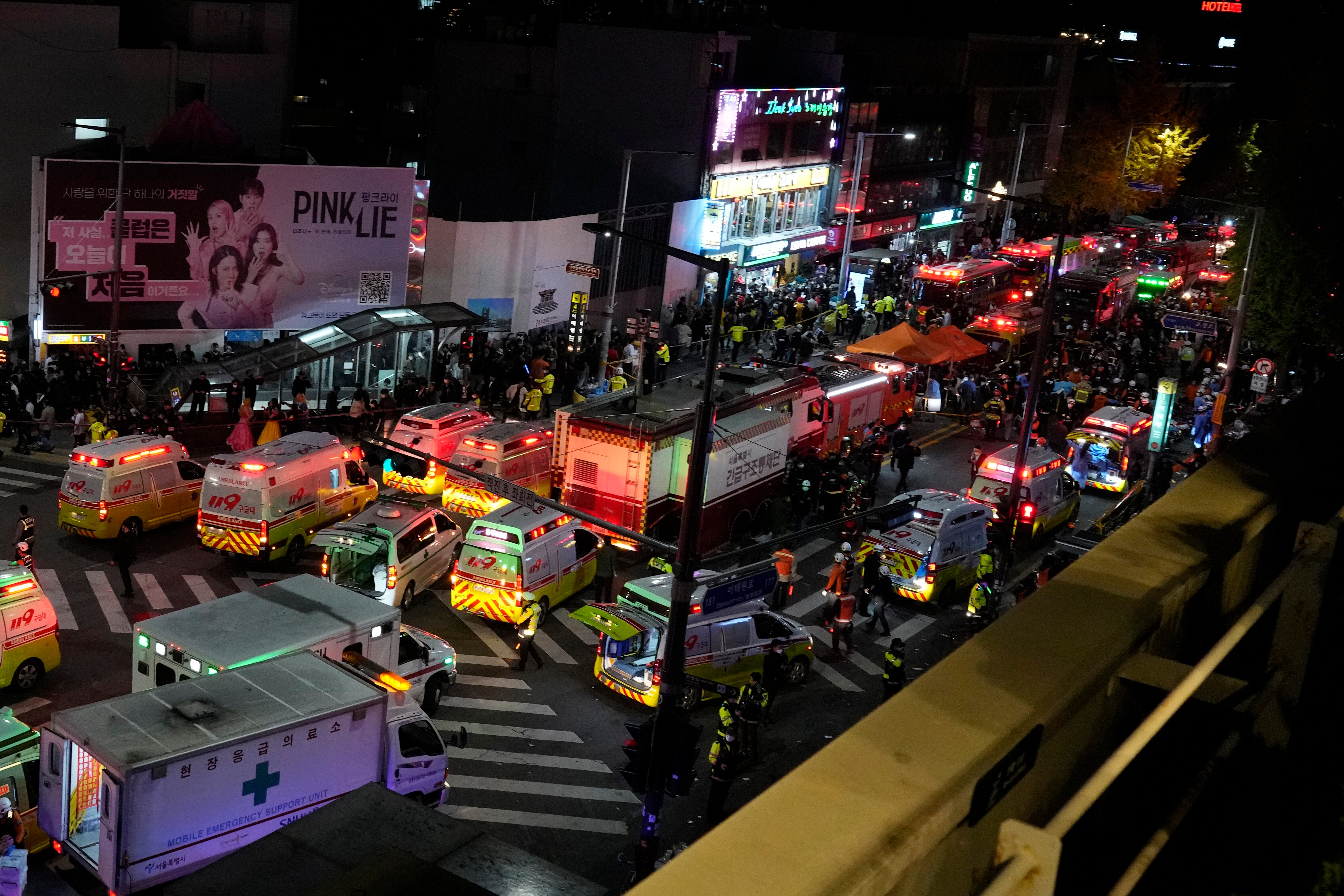 Ambulances and rescue workers arrive at the street near the scene of a crowd surge in Seoul. (AP)