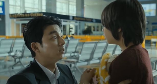 A still photo of Gong Yoo and Kim Su-an heading to Busan from the train.
