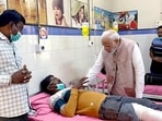 Prime Minister Narendra Modi meets an injured person of the Morbi cable bridge collapse mishap, at the Civil Hospital.(ANI)