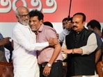 Actors Rajinikanth hugs actor Shiva Rajkumar as Karnataka Chief Minister Basavaraj Bommai looks on, during a ceremony for the Karnataka Ratna Award presentation. Actors Rajinikanth hugs actor Shiva Rajkumar as Karnataka Chief Minister Basavaraj Bommai looks on, during a ceremony for the Karnataka Ratna Award presentation.