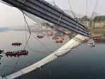 Rescue personnel conduct search operations after a bridge across the river Machchhu collapsed at Morbi in Gujarat. (AFP) Rescue personnel conduct search operations after a bridge across the river Machchhu collapsed at Morbi in Gujarat. (AFP)