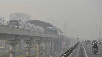 A metro train runs on a track amid low visibility due to a thick layer of smog in Gurugram on Tuesday. (ANI)