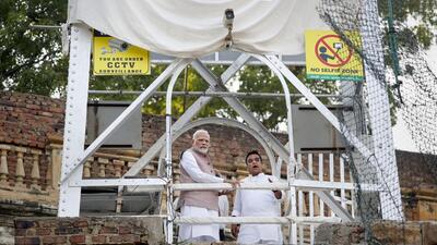 Prime Minister Narendra Modi with Gujarat Home Minister Harsh Sanghavi at the site to take stock of the situation after an old suspension bridge over the Machchhu river collapsed on Sunday evening, in Morbi district, Tuesday, Nov. 1, 2022. (PTI) Prime Minister Narendra Modi with Gujarat Home Minister Harsh Sanghavi at the site to take stock of the situation after an old suspension bridge over the Machchhu river collapsed on Sunday evening, in Morbi district, Tuesday, Nov. 1, 2022. (PTI)