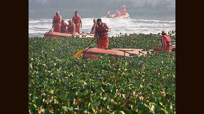 Rescuers carry out search operations in Machchu river. (AP) Rescuers carry out search operations in Machchu river. (AP)
